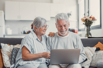House, laptop and senior couple on sofa, finance planning or connection in living room. Mature...
