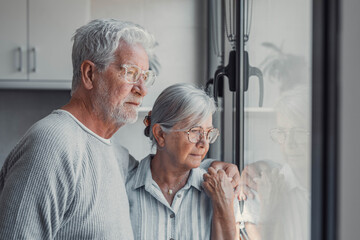 Anxious scared elderly couple embracing, facing troubles together. Family love, senior years in...