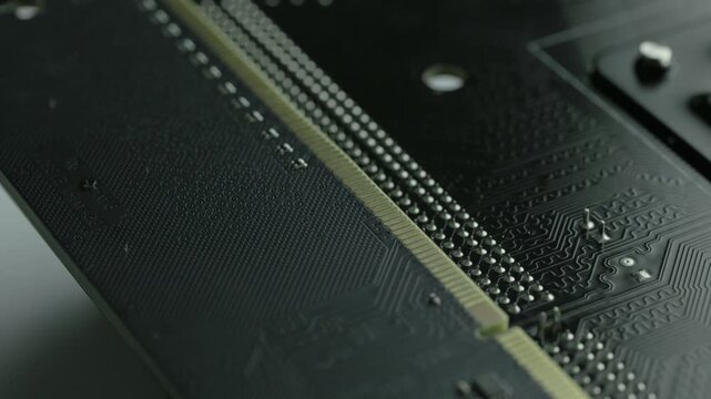 KYIV, UKRAINE - DECEMBER 20, 2025: Backward of computer motherboard and memory stick 