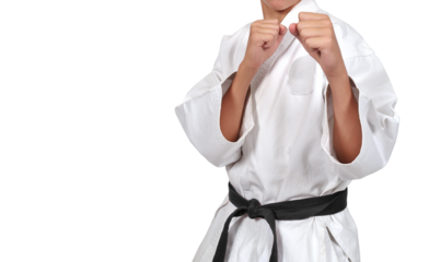 A young karate guy assumed a fighting stance with his hands forward.