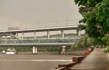 The Moskva River embankment. A wet pedestrian walkway after a summer rain