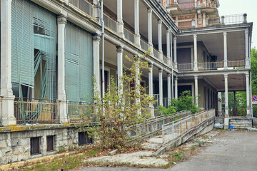 Abandoned hospital courtyard with classical architecture