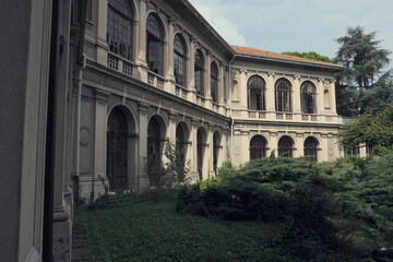Abandoned hospital courtyard with classical architecture