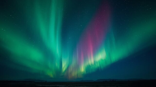 Mesmerizing aurora borealis dancing across a starry night sky, creating vibrant green and purple light waves over a dark horizon. Perfect for nature, astronomy, and atmospheric backgrounds.