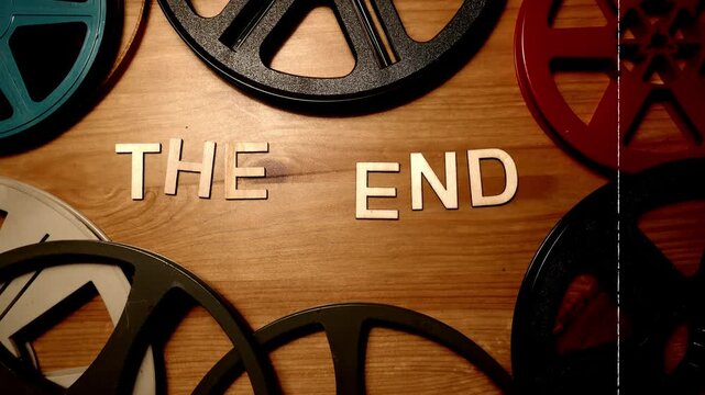 Animated stop motion wood letters spelling out the works The End. Bordered by vintage film reels and edited with film damage.
