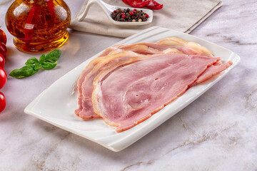 Sliced pork ham over board