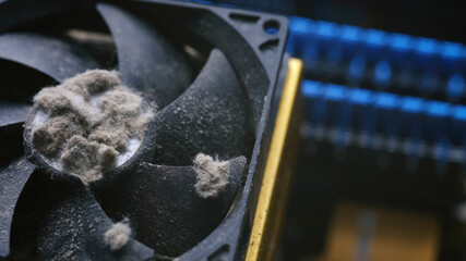 Close-up shot showing mounds of thick dust clogging a PC cooling fan.