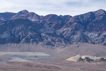 Death Valley National Park, Inyo County. California State Route 190. In the distance is Black Mountains (Amargosa Range System). Artist Drive Formation near Ryan (former mining community).