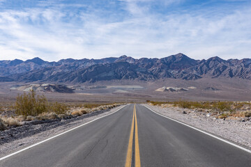 Fototapeta premium Alluvial deposits. Death Valley National Park, Inyo County. California State Route 190. In the distance is Black Mountains (Amargosa Range System).