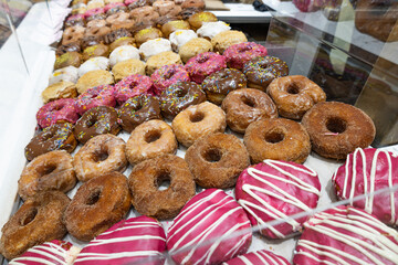 Assorted Fresh Donuts in Bakery Display Case
