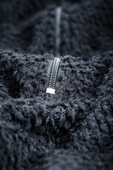 Zipper on black fleece background close-up