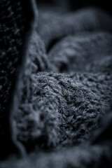 The texture of a soft black fleece fabric with visible fibers and folds © Alexander