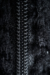 Zipper on black fleece background close-up