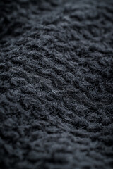 The texture of a soft black fleece fabric with visible fibers and folds © Alexander