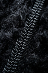 Zipper on black fleece background close-up
