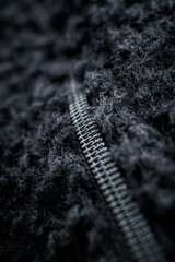 Zipper for clothes black on fleece fabric in macro