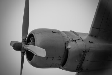 Vintage airplane propeller spinning in the sky during an overcast day, showcasing aviation history and engineering marvels © funkenzauber