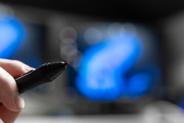 Designer Holding Using Stylus Pen Mid Air Against Blurry Blue Screens, Notetaking And Drawing For Design Productivity, Creative Workflow And Elearning Apps