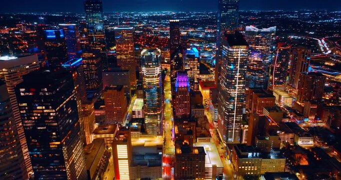 Bright illumination of Houston, Texas, USA at night. Drone footage over the luminous street in the city downtown.