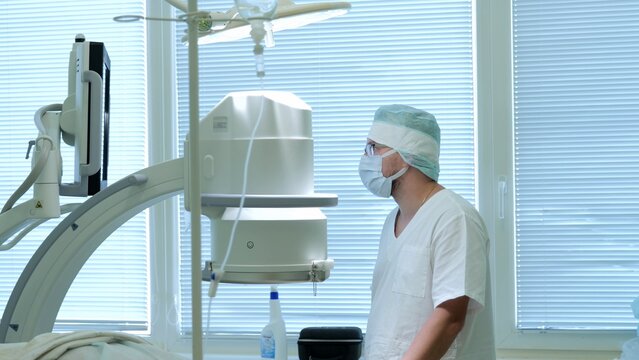 Russia Tomsk 05.07.2025: Medical team ensures imaging device is precisely aligned and functioning properly, Healthcare professionals verify safety and accuracy during imaging system