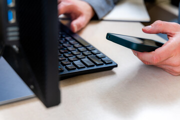 Smartphone In Office Beside Keyboard Computer For Multitasking Communication, Notifications And Work Productivity, Business Calls Messaging And Quick Mobile Updates