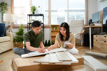 couple assembling wooden furniture together, Young asian couple assembly a new furniture at home