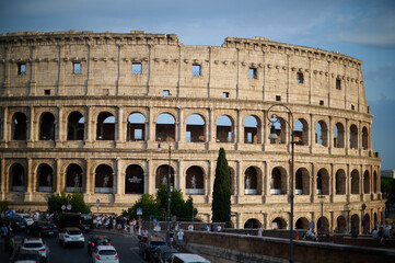 Obraz premium The iconic Roman Colosseum at sunset featuring the ancient stone arches and monumental architecture of the historic Flavian Amphitheatre in Rome Italy