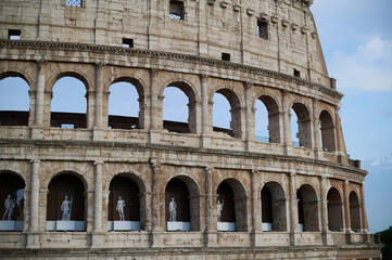 The iconic Roman Colosseum at sunset featuring the ancient stone arches and monumental architecture of the historic Flavian Amphitheatre in Rome Italy