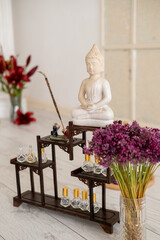 Spiritual statue. Buddha practice. Tool for calming relaxing meditation healing treatment oil flower for aromatherapy placed on floor.