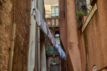 Tourist walking through narrow Venetian streets contemplating the scenic canals and traditional gondolas in Venice Italy