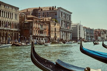 Tourist walking through narrow Venetian streets contemplating the scenic canals and traditional gondolas in Venice Italy
