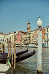 Tourist walking through narrow Venetian streets contemplating the scenic canals and traditional gondolas in Venice Italy