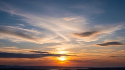 Serene Sunset Over Distant Horizon with Wispy Clouds Painting the Sky
