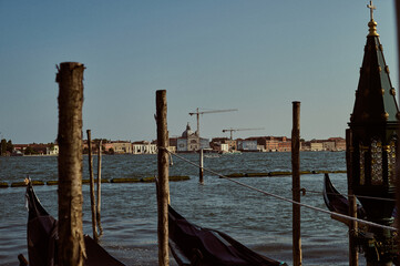 Tourist walking through narrow Venetian streets contemplating the scenic canals and traditional gondolas in Venice Italy