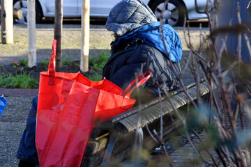Un senzatetto in citt&agrave; seduto sulla panchina in inverno