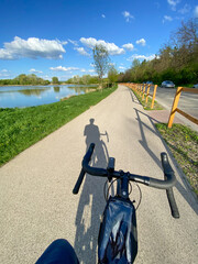 cyclist shadow on lakeside bike path