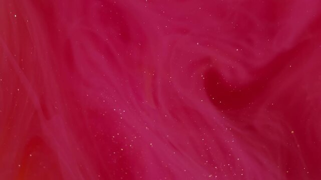 Red paint. Glitter vapor. Blur vibrant color sparkling texture splash underwater fog spreading on abstract bokeh acrylic art background.