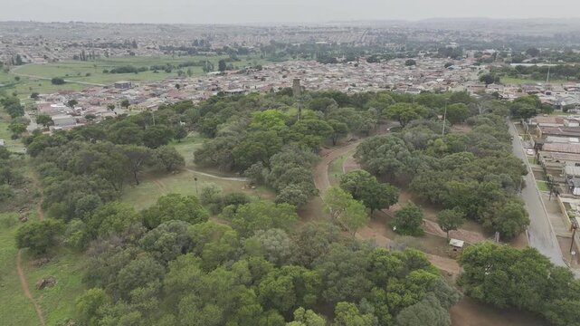 Drone flies the length of  Credo Mutwa Cultural Village, Soweto, South Africa on overcast day