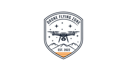 Obraz premium A cool and adventurous emblem for a 'Drone Flying Zone,' featuring a quadcopter over mountains within a shield-shaped patch.