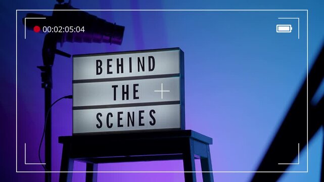 BTS. Behind the scene light box in front of vdo camera frame. Black text on white lightbox of word Behind the scenes. Prop for filmmaker in studio lights. BTS Footage for video production making of.