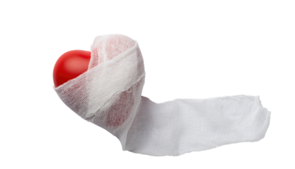 Valentine day red heart wrapped in white fabric with flowing end creating a romantic theme on white and transparent