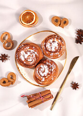 Buns or muffins with nuts, cinnamon, poppy seeds, and egg liqueur.Festive kitchen banner. The concept of festive pastries, seasonal treats and cafe advertisements, restaurant menus. Homemade dessert,