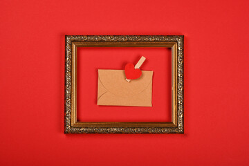 Brown paper envelope in golden frame on red