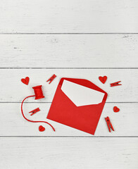Preparing Valentine red envelope on white table