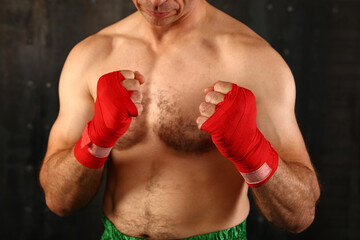 Boxer with red wrist wraps on hands