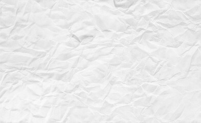 Obraz premium White crumpled paper texture background featuring soft wrinkles and natural creases. Perfect for editorial design, handmade aesthetics, overlays, stationery, and artistic layouts.