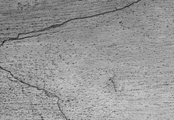 Obraz premium Close-up of aged concrete with fine cracks and granular detail, ideal for industrial backgrounds, urban design projects, grunge textures, and minimalist compositions.