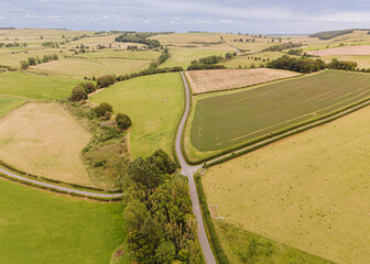 Northumberland England: Aug 2025: Scenic view of country roads winding through fields in Northumberland England during daytime