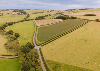 Northumberland England: Aug 2025: Scenic view of country roads winding through fields in Northumberland England during daytime