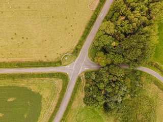Northumberland England: Aug 2025: Country roads meet at a junction in Northumberland England surrounded by fields and trees